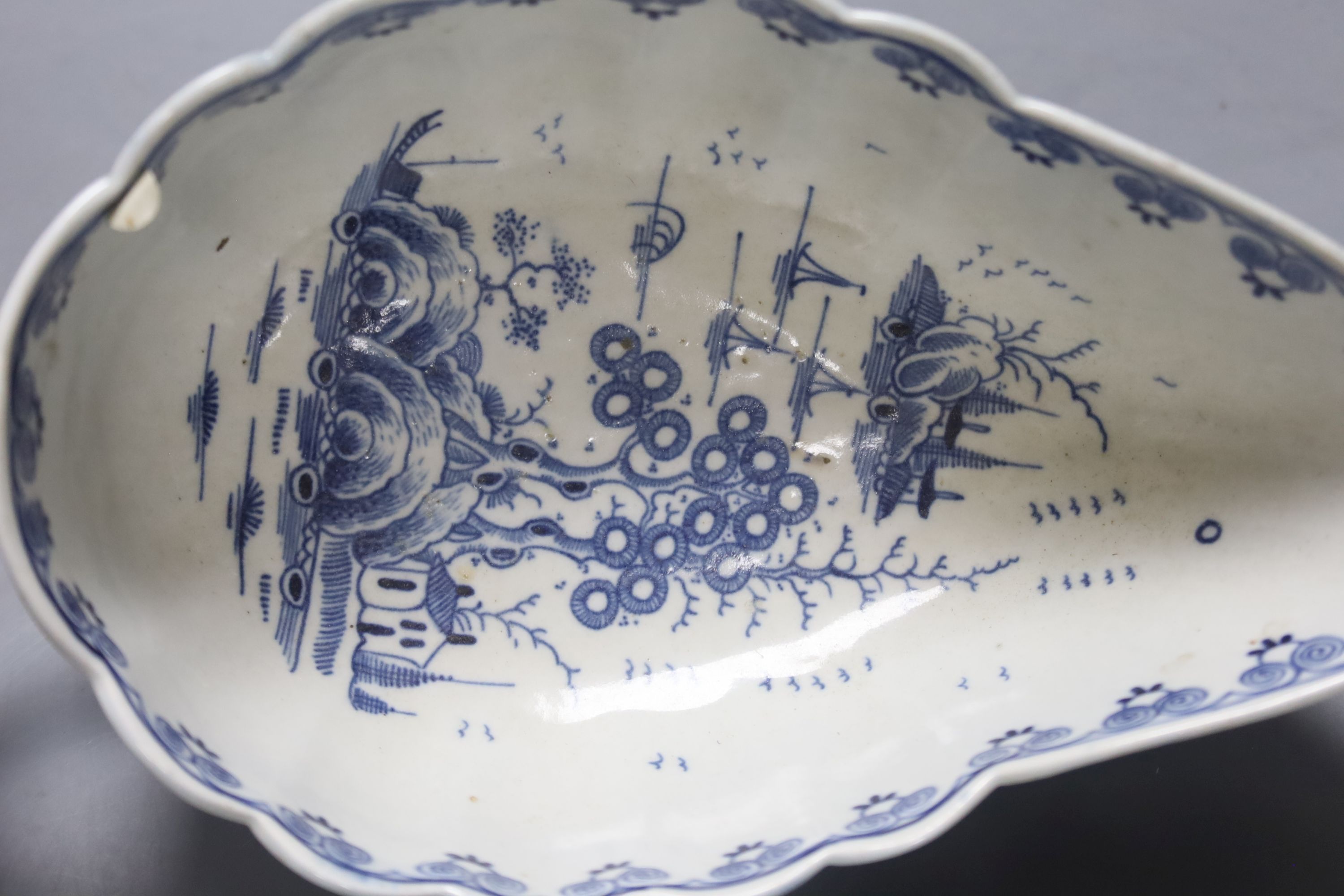 A Worcester Doughnut pattern blue and white sauceboat circa 1775 and two Chinese blue and white sauceboats, Qianlong period, longest 21cm